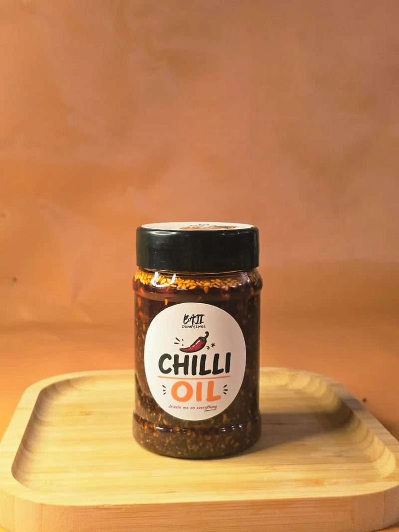 Baji Dumplings chilli oil jar on a wooden board