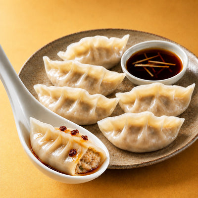 Peppered beef dumplings with a bowl of dipping sauce