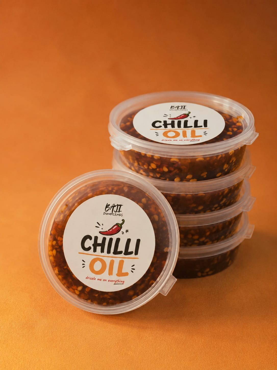 A stack of sealed Baji chilli oil dip tubs